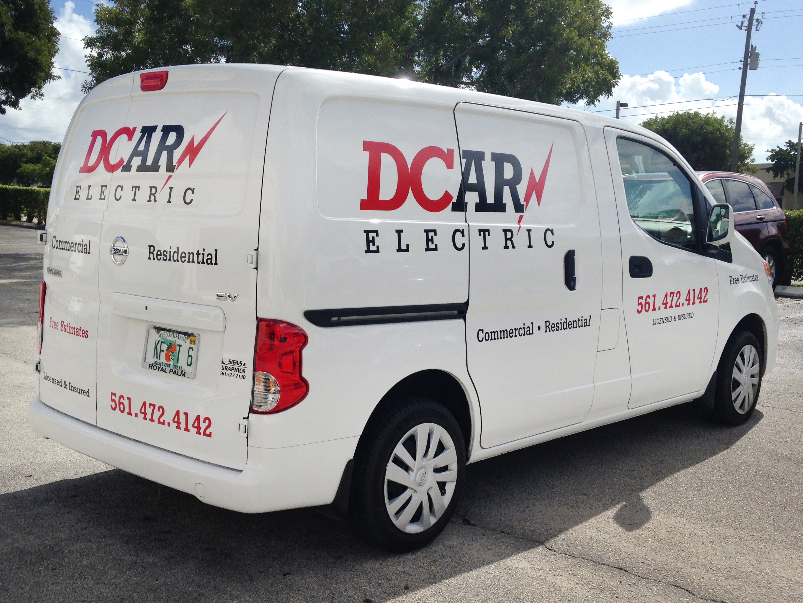 Business vehicle with professional vehicle graphics wrap displaying company branding and contact information for mobile advertising